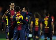 Barcelona's forward Lionel Messi (C) celebrates with midfielder Sergio Busquets (L) and defender Adriano (R)